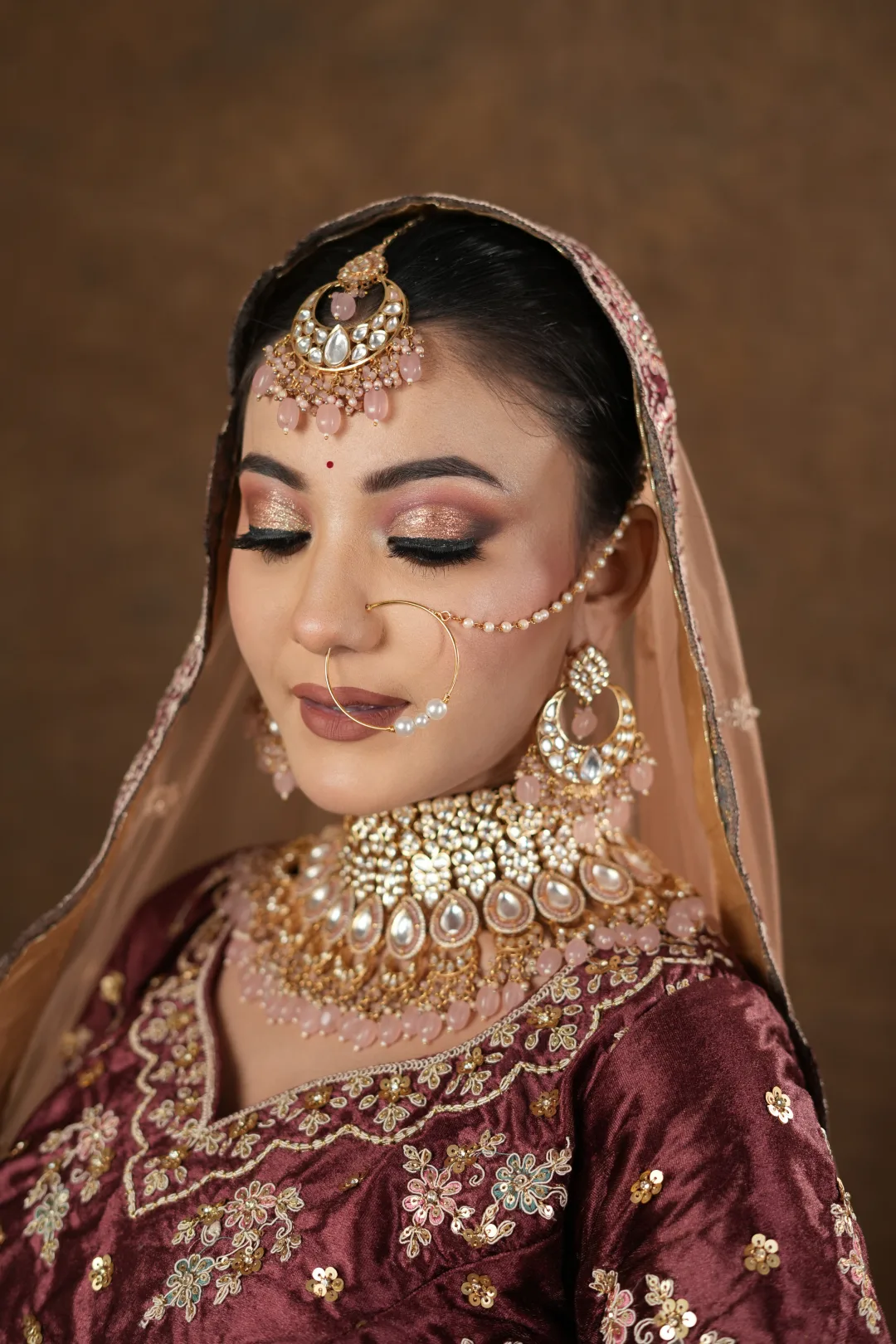 Close view of softly blended bridal eye makeup with traditional jewellery.