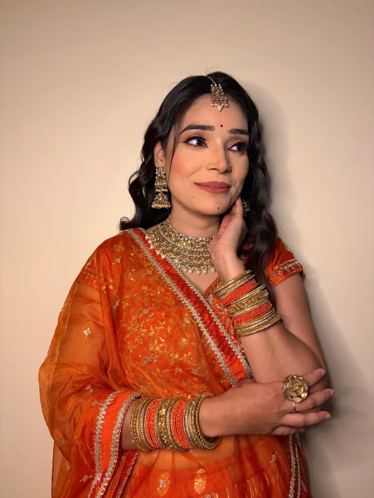 Warm occasion makeup with softly defined eyes, styled hair and traditional jewellery.